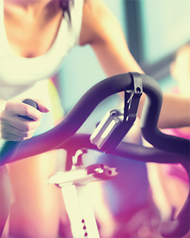 A photo of a woman on an exercise bike