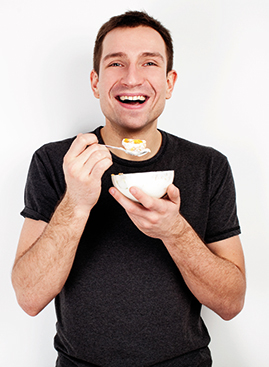 A photo of a man with a bowl of food