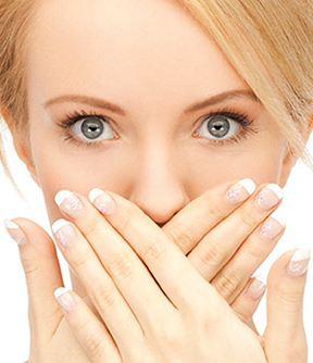 A photo of a girl with her hands across her face