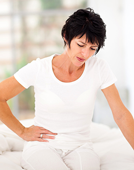 A photo of a woman holding her stomach