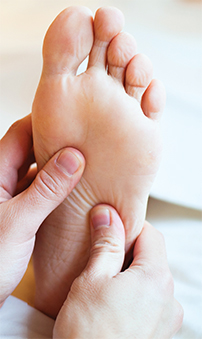 A photo of a foot being massaged