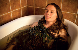 A woman having a seaweed bath