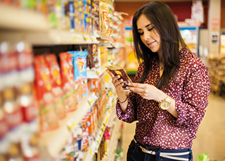 A photo of a woman checking allergy information on a product